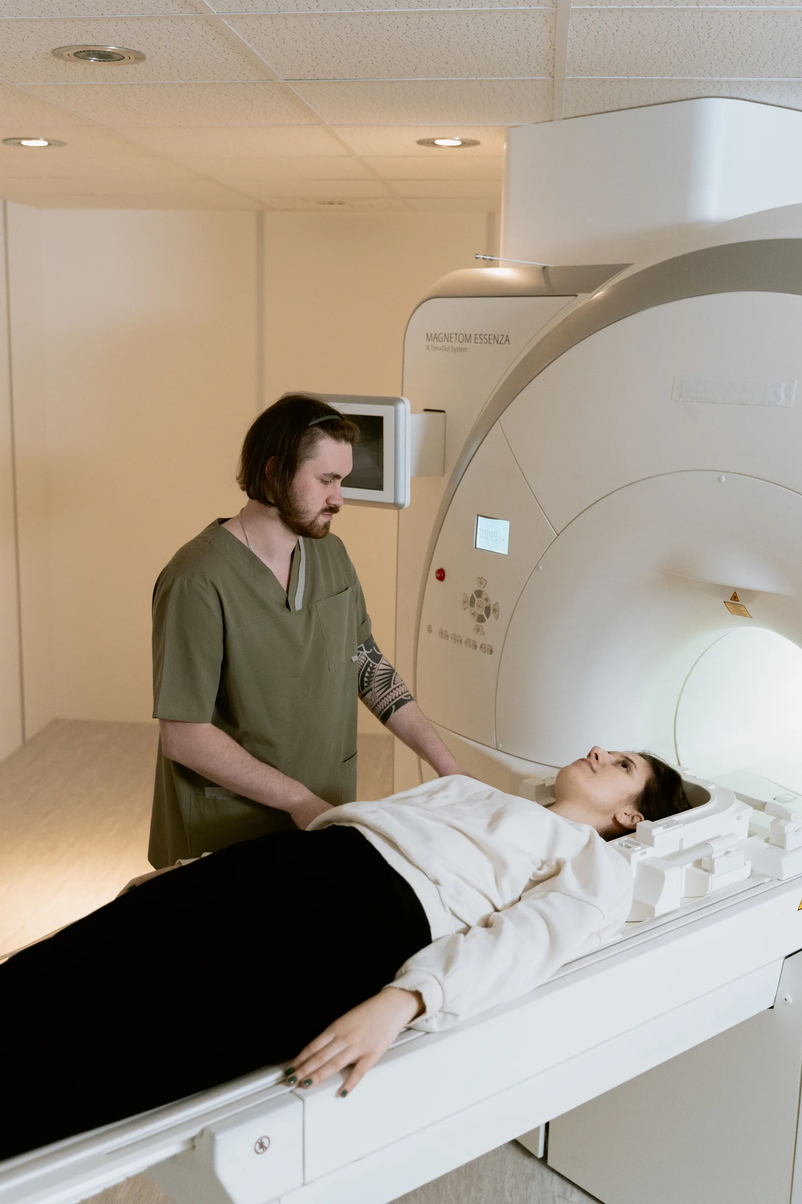 Radiologist evaluating diagnostic CT, MRI, and fluoroscopy imaging studies at workstation