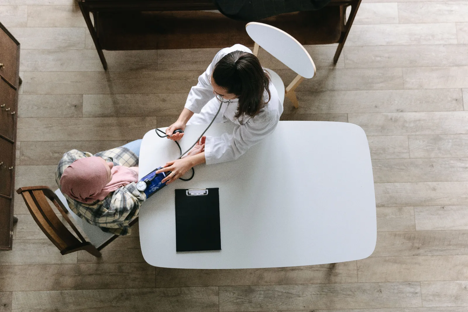 Family medicine physician conducting comprehensive patient consultation and vital signs exam